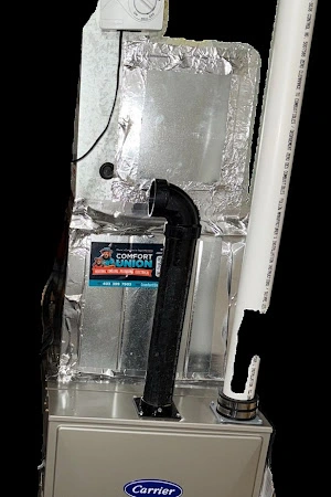 Energy-efficient Carrier furnace paired with Bradford White water heater in a utility room.