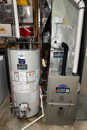 Carrier furnace and Bradford White water heater installed side by side with professional piping.