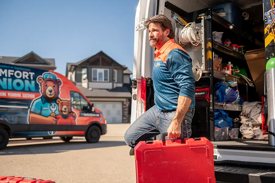 Trusted Comfort Union technician with toolkit and branded van