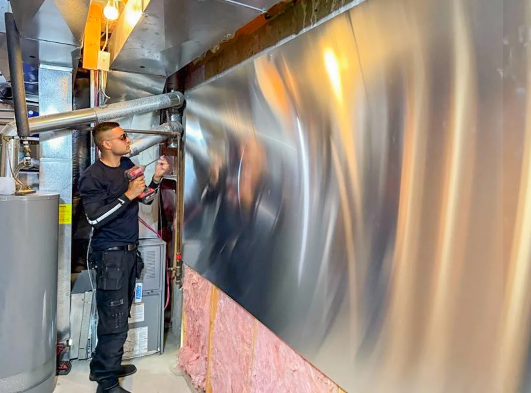 Comfort Union technician installing an IBC boiler in a Calgary home utility room