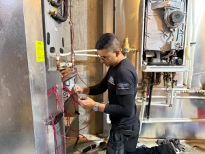 Comfort Union Technician installing a fan coil