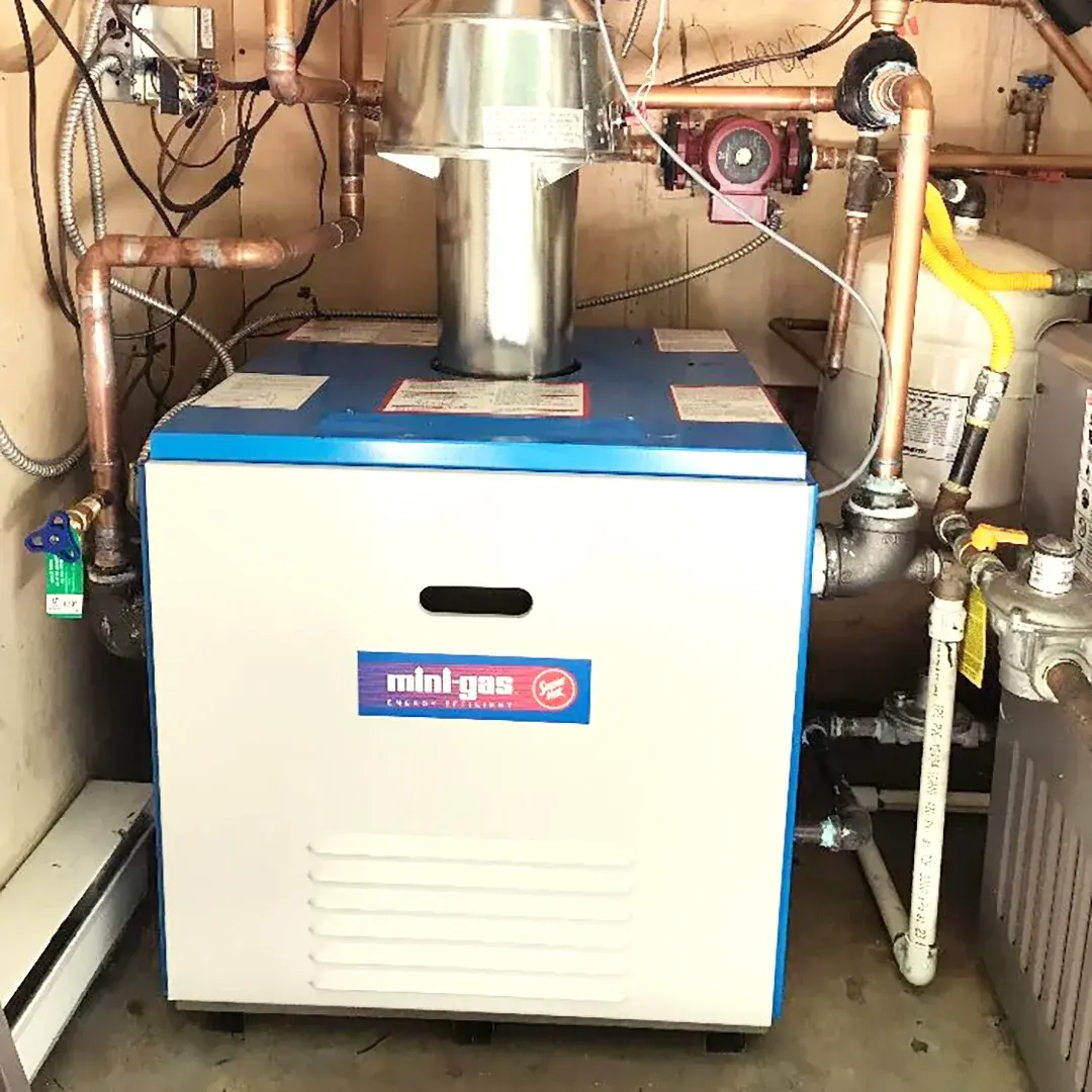 Old residential boiler system in a Calgary home before replacement by Comfort Union technician