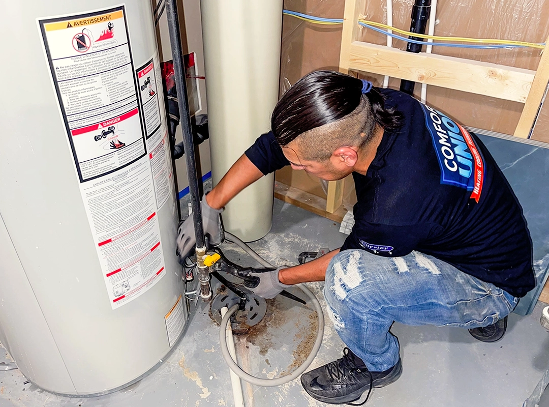 hot water tank maintenance being performed by technician