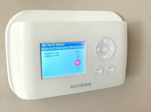 Smart thermostat installed on a wall controlling a furnace in a Calgary home