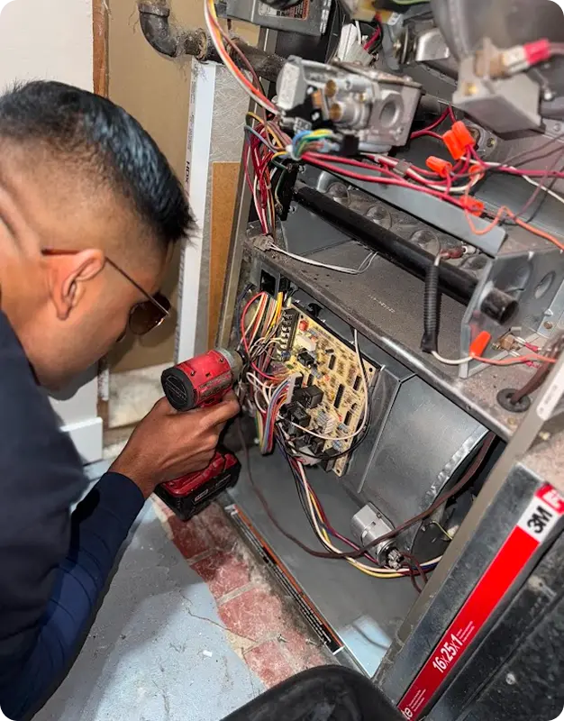 Comfort Union HVAC technician performing repair service with tools at job site