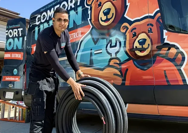 Comfort Union technician rolling flexible pipes for HVAC installation work
