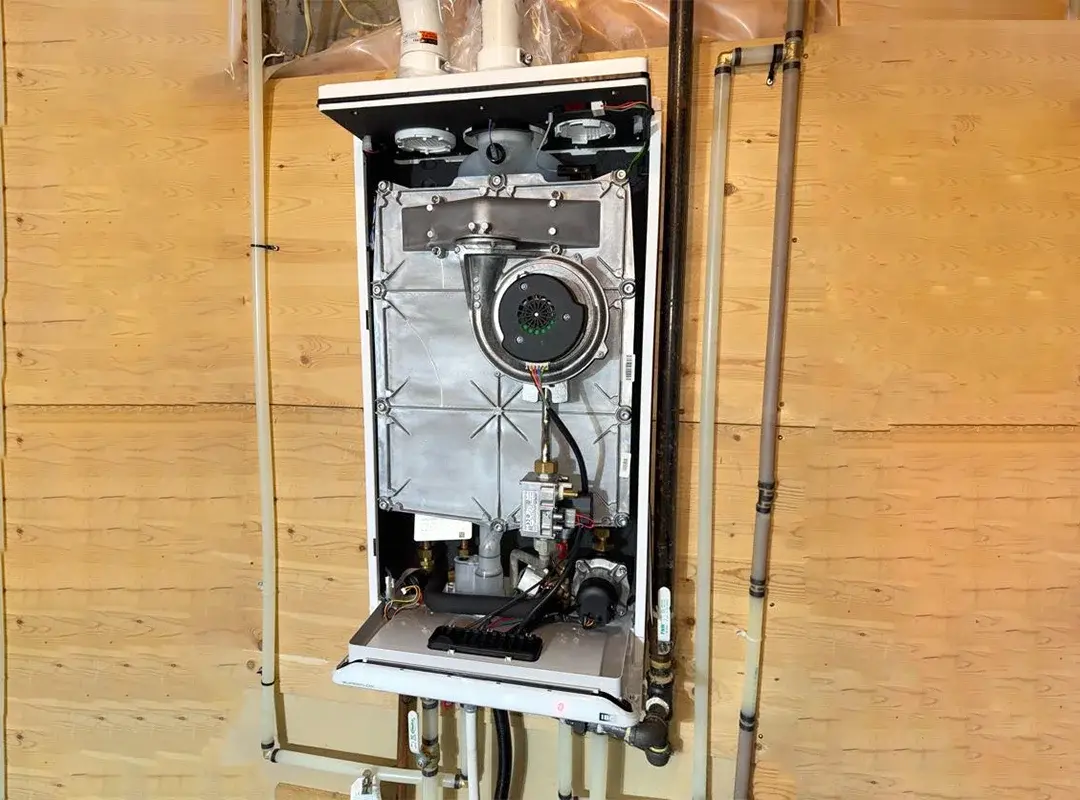 Old tankless water heater setup before replacement in Calgary