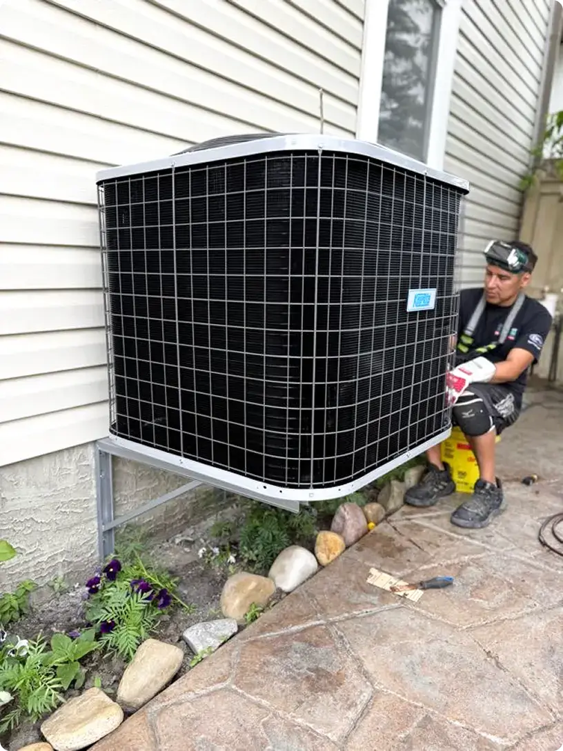 Comfort Union technician installing a central air conditioner in Calgary